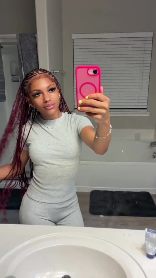 Client wearing long burgundy knotless braids