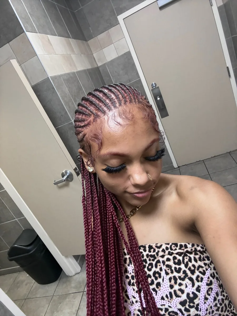 Client wearing burgundy feed-in braids